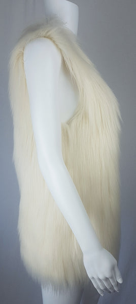 Full side view of a cream long-pile faux-fur vest with a collarless neckline, decorative fastening and side pockets displayed on a mannequin