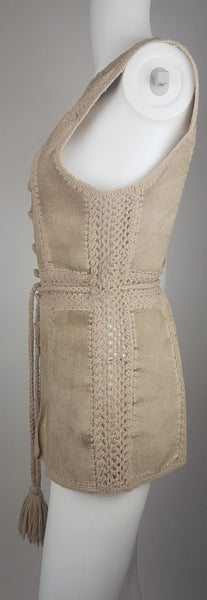 Full side view of a vintage 60s - 70s Hudson Bay Company sand-beige suede vest with crochet panel joins and a long tassel tie belt.