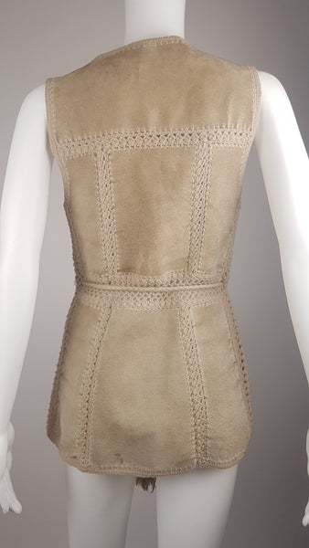 Full back view of a vintage 60s - 70s Hudson Bay Company sand-beige suede vest with crochet panel joins and a long tassel tie belt.