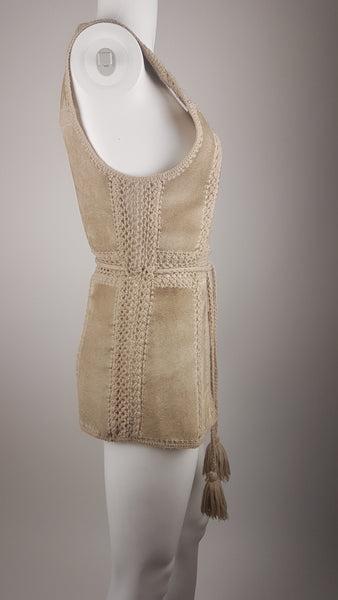 Full side view of a vintage 60s - 70s Hudson Bay Company sand-beige suede vest with crochet panel joins and a long tassel tie belt.