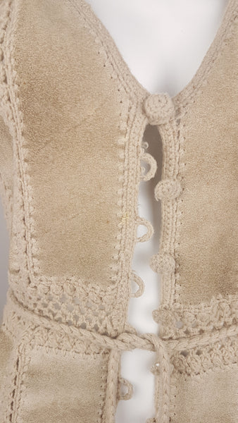 Front view of the crochet-covered buttons and loop fastenings along the front of the vintage suede vest.