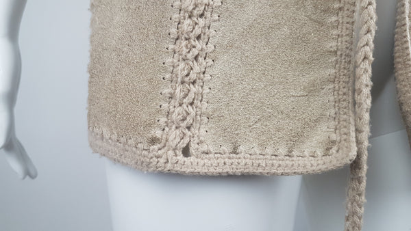 Condition close-up of the lower suede panel showing surface marks and a small gap in the crochet join near the hem.