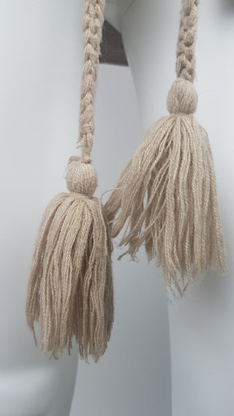 Close-up of the long braided acrylic tie belt finished with two oversized yarn tassels on a vintage 60s - 70s Hudson Bay Company vest
