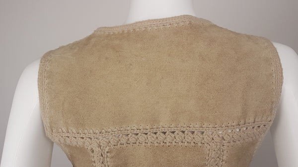 Upper back shoulder view of a vintage 60s - 70s Hudson Bay Company panelled beige suede vest with a wide crochet waistband and visible natural patina displayed on a mannequin