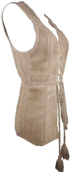Three-quarter side view of a vintage 60s - 70s Hudson Bay Company sand-beige suede vest with crochet panel joins and a long tassel tie belt.