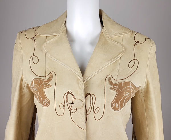 Closer upper front view of the notched collar, longhorn appliqués and brown lariat embroidery on a Geronimo leather jacket.