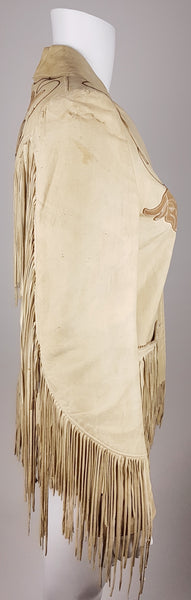 Full side profile of a fitted sand-beige leather Western jacket with long fringe extending from the shoulder to the cuff.