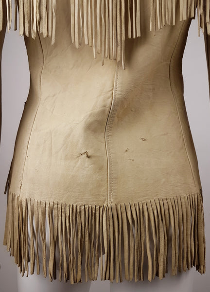Condition close-up of the lower back showing creasing, several small cuts and uneven aged leather fringe.