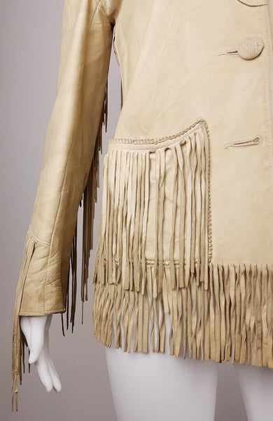 Lower front close-up showing a heavily fringed patch pocket, aged sleeve and hem fringe, and the empty lowest buttonhole.
