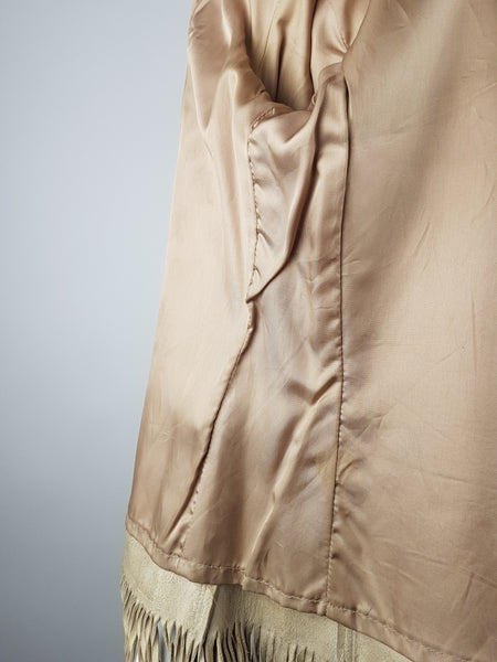 Interior condition close-up of the champagne-coloured satin lining and leather fringe at the lower edge.