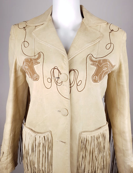 Upper front view of a vintage Geronimo leather jacket with notched lapels, two longhorn appliqués and looping lariat embroidery.