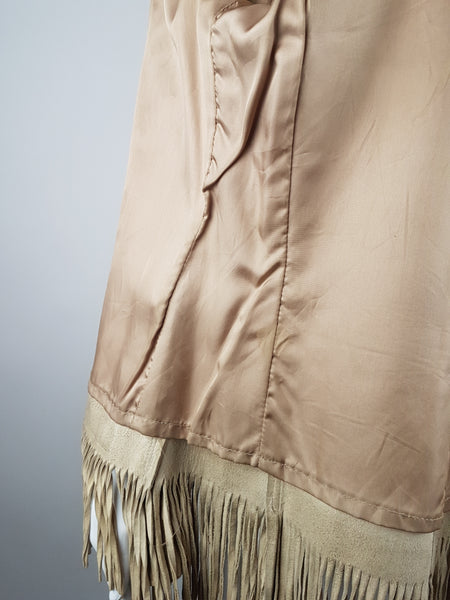 Interior close-up of the champagne-coloured satin lining and leather fringe along the lower hem.