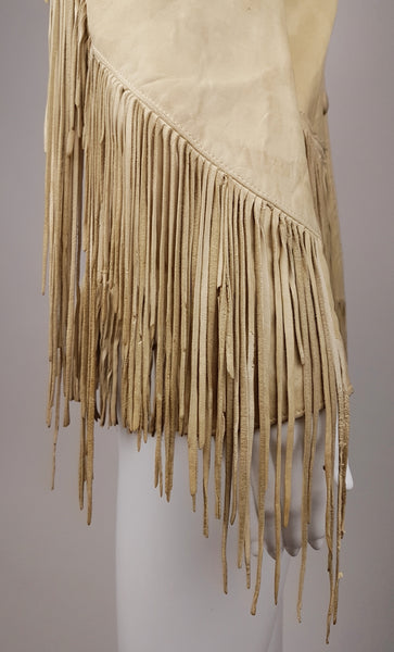 Close-up of the long, uneven leather fringe extending from the outer sleeve of the vintage Western jacket.