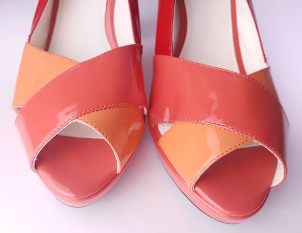 Toebox closeup of unworn Geox Respira colour-block platform sandals in red, coral and peach, with crossover peep toes, block heels and buckled slingback straps.