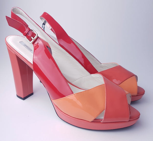 Three-quarter view of unworn Geox Respira colour-block platform sandals in red, coral and peach, with crossover peep toes, block heels and buckled slingback straps.