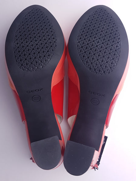 Sole details of unworn Geox Respira colour-block platform sandals in red, coral and peach, with crossover peep toes, block heels and buckled slingback straps.