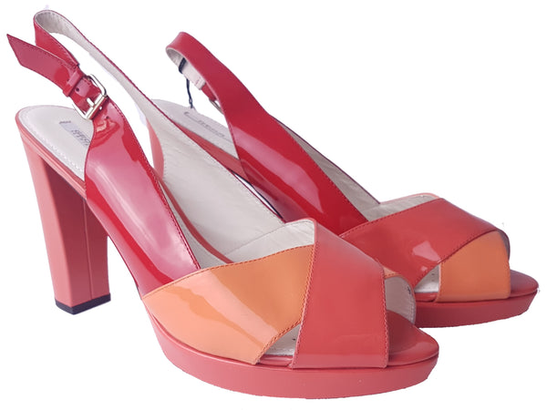 Three-quarter view of unworn Geox Respira colour-block platform sandals in red, coral and peach, with crossover peep toes, block heels and buckled slingback straps.