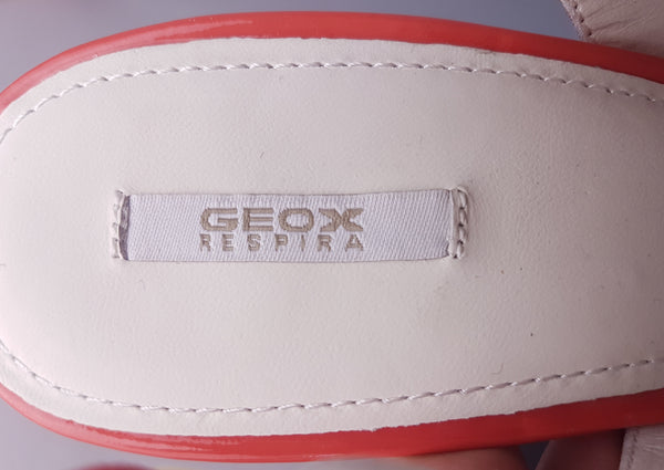 Shoe label closeup of unworn Geox Respira colour-block platform sandals in red, coral and peach, with crossover peep toes, block heels and buckled slingback straps.