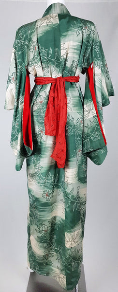 Full back view of a vintage Japanese green silk kimono styled with a red scarf sash at the waist.