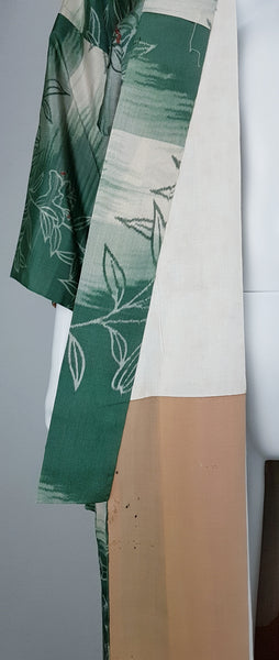 Interior view of the cream and peach-toned kimono lining showing several dark marks and small areas of moth damage.