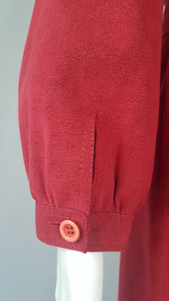 Sleeve and cuff view of Vintage 1970's Halston Ultra Suede red knee length wrap coat dress with long sleeves, a wide collar, and a matching tie belt on a mannequin 
