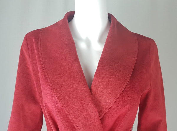 Collar view of Vintage 1970's Halston Ultra Suede red knee length wrap coat dress with long sleeves, a wide collar, and a matching tie belt on a mannequin 