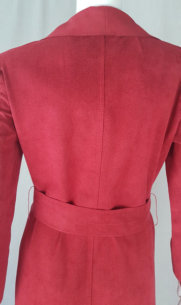 Back view of Vintage 1970's Halston Ultra Suede red knee length wrap coat dress with long sleeves, a wide collar, and a matching tie belt on a mannequin 