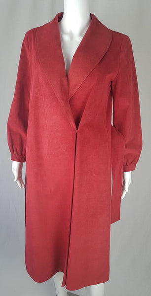 Tie belt undone view on Vintage 1970's Halston Ultra Suede red knee length wrap coat dress with long sleeves, a wide collar, and a matching tie belt on a mannequin 
