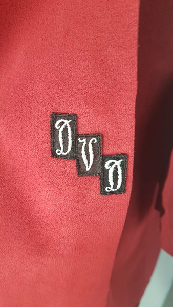 Inner monogram view of Vintage 1970's Halston Ultra Suede red knee length wrap coat dress with long sleeves, a wide collar, and a matching tie belt on a mannequin 