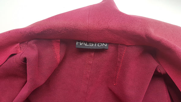 Label view of Vintage 1970's Halston Ultra Suede red knee length wrap coat dress with long sleeves, a wide collar, and a matching tie belt on a mannequin 