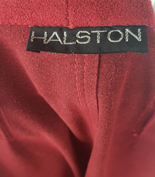 Label view of Vintage 1970's Halston Ultra Suede red knee length wrap coat dress with long sleeves, a wide collar, and a matching tie belt on a mannequin 