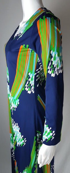 Closer side view of a vintage 1970s Lanvin maxi dress showing its topstitched V-neckline and cascading abstract print.
