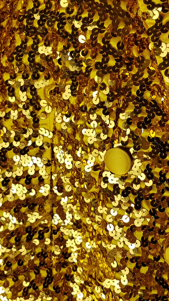 Condition close-up showing minor loose threads and disrupted sequins beside a satin-covered button near the rear tail split.
