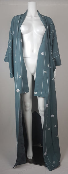 Blue grey kimono robe displayed on a mannequin, with wide sleeves, white vertical stripes and white floral medallions - front view