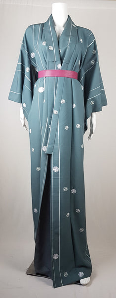 Blue grey kimono robe displayed on a mannequin, with wide sleeves, white vertical stripes and white floral medallions, accented with a magenta pink belt that is not included with the kimono - front view