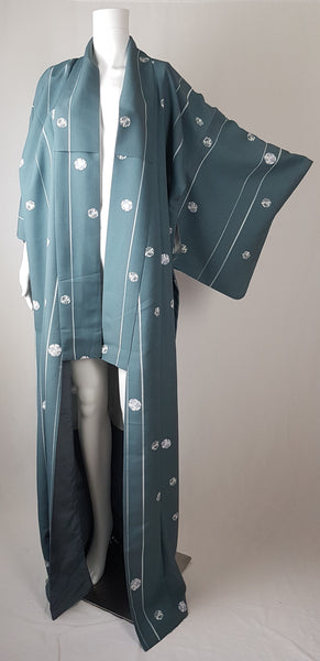 Blue grey kimono robe displayed on a mannequin, with wide sleeves, white vertical stripes and white floral medallions - front view