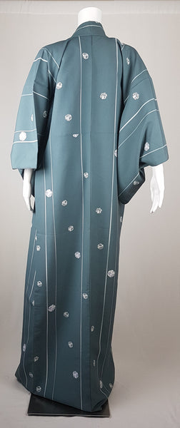 Blue grey kimono robe displayed on a mannequin, with wide sleeves, white vertical stripes and white floral medallions - back view