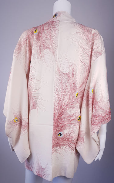 Vintage 1950s to 1960s Japanese haori on a mannequin, featuring red peacock feather motifs with blue, yellow, black and metallic gold details - back view