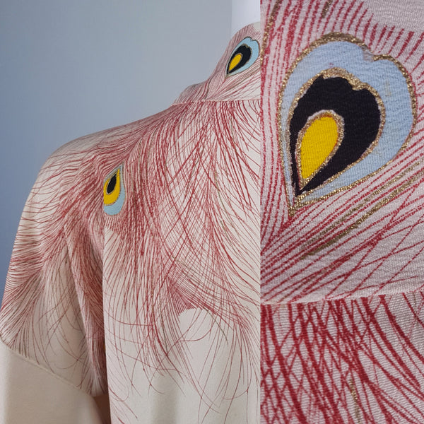 Fabric closeup on Vintage 1950s to 1960s Japanese haori, featuring red peacock feather motifs with blue, yellow, black and metallic gold details 