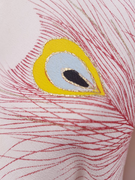 Closeup of peacock feather motif on Vintage 1950s to 1960s Japanese haori, featuring red peacock feather motifs with blue, yellow, black and metallic gold details