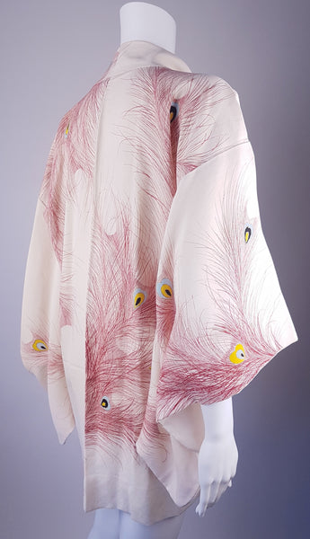 Vintage 1950s to 1960s Japanese haori on a mannequin, featuring red peacock feather motifs with blue, yellow, black and metallic gold details - side back view