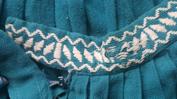 Fabric snags of waist on Vintage 1950s Mayan Modern Guatemalan cotton skirt in rich blue and white with traditional geometric woven motifs displayed on a mannequin - detailed motif view