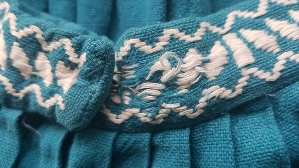 Fabric snags of waist on Vintage 1950s Mayan Modern Guatemalan cotton skirt in rich blue and white with traditional geometric woven motifs displayed on a mannequin - detailed motif view