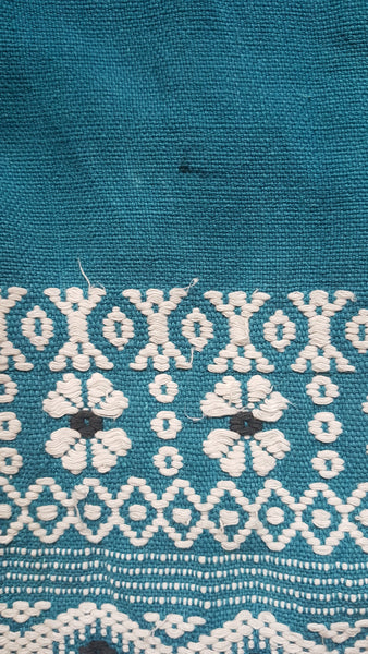 Minor flaw of a small penmark on Vintage 1950s Mayan Modern Guatemalan cotton skirt in rich blue and white with traditional geometric woven motifs displayed on a mannequin - detailed motif view