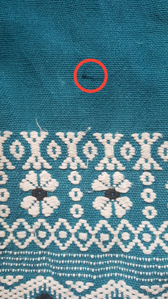 Minor flaw of a small penmark circled in red on Vintage 1950s Mayan Modern Guatemalan cotton skirt in rich blue and white with traditional geometric woven motifs displayed on a mannequin - detailed motif view