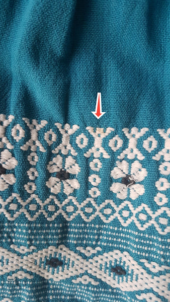 Minor flaws shown with red arrow of a Vintage 1950s Mayan Modern Guatemalan cotton skirt in rich blue and white with traditional geometric woven motifs displayed on a mannequin - detailed motif view