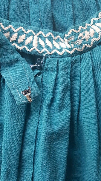 Hook and eye closure of Vintage 1950s Mayan Modern Guatemalan cotton skirt in rich blue and white with traditional geometric woven motifs displayed on a mannequin