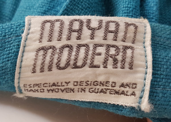 Closeup of label of Vintage 1950s Mayan Modern Guatemalan cotton skirt in rich blue and white with traditional geometric woven motifs 