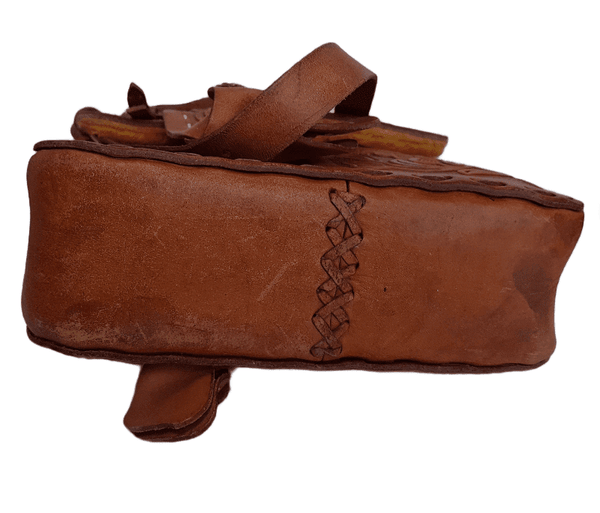 Bottom view of a vintage 1960s Mexican tooled-leather crossbody bag constructed as a miniature Western horse saddle.