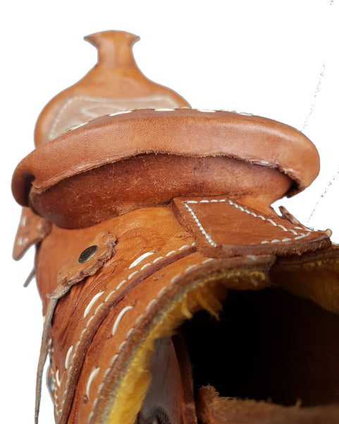 Stitching view of a vintage 1960s Mexican tooled-leather crossbody bag constructed as a miniature Western horse saddle 